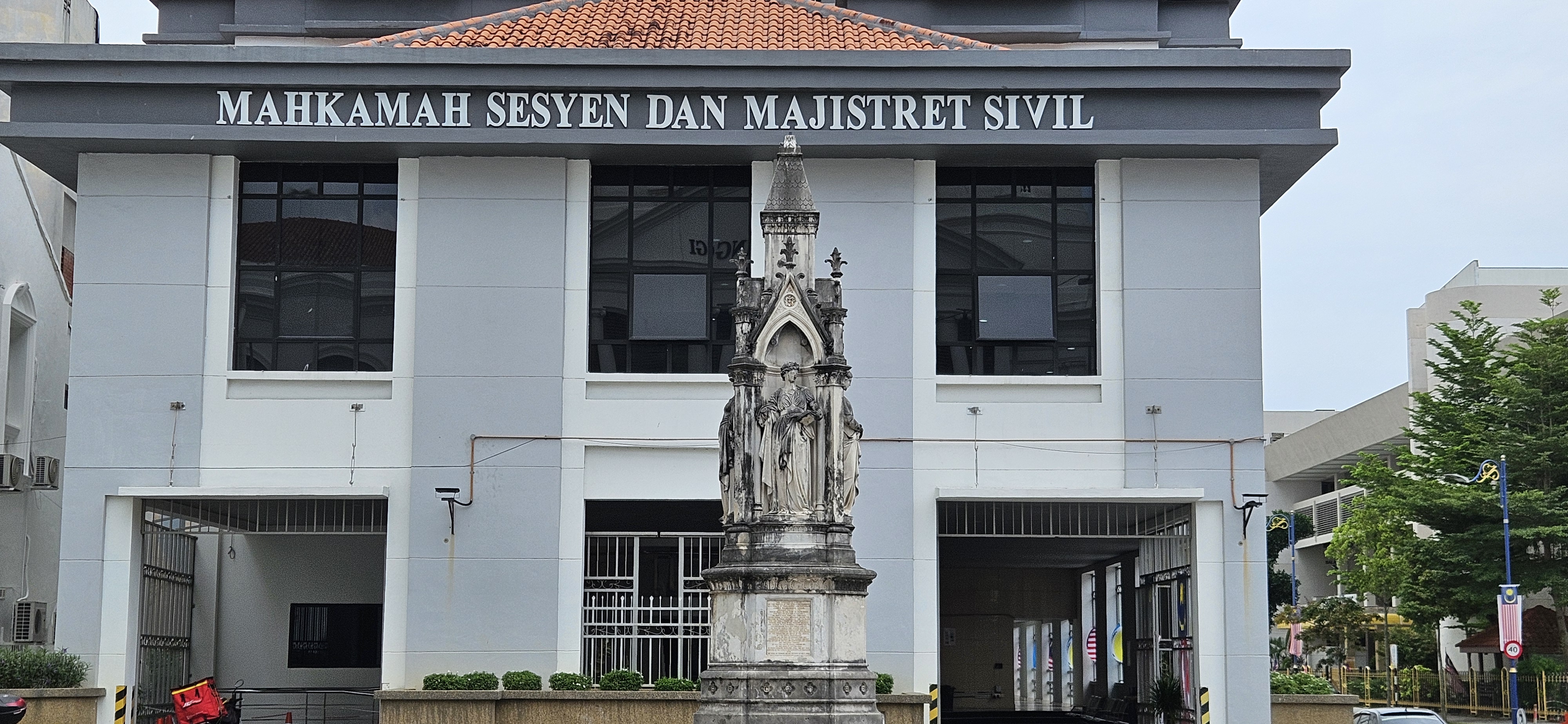 Front view of the Session and Civil Magistrate Court building, featuring a decorative statue in front.